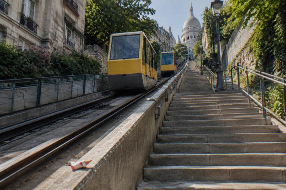 The Montmartre funicular cabins on their inclined track beside a public staircase