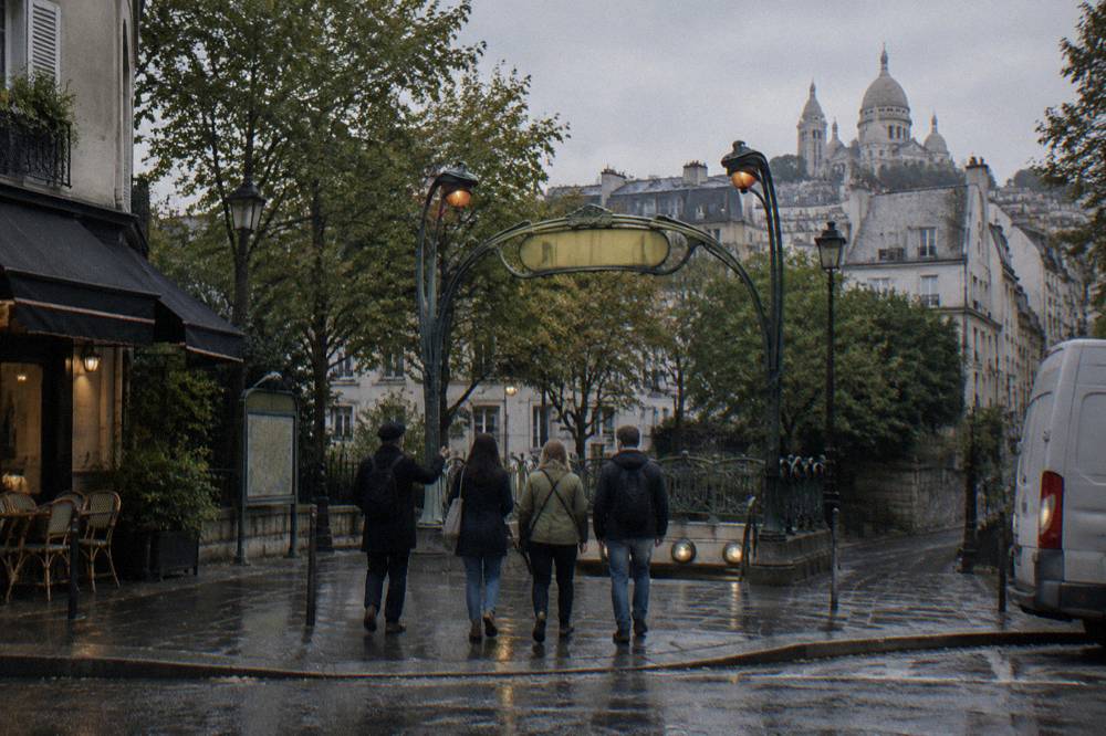 A guide leading a small group along a Montmartre street past food shops