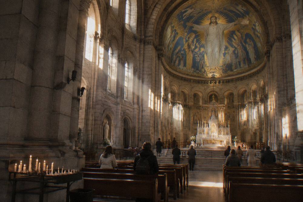 The interior of the Sacre-Coeur basilica with its golden apse mosaic above the altar