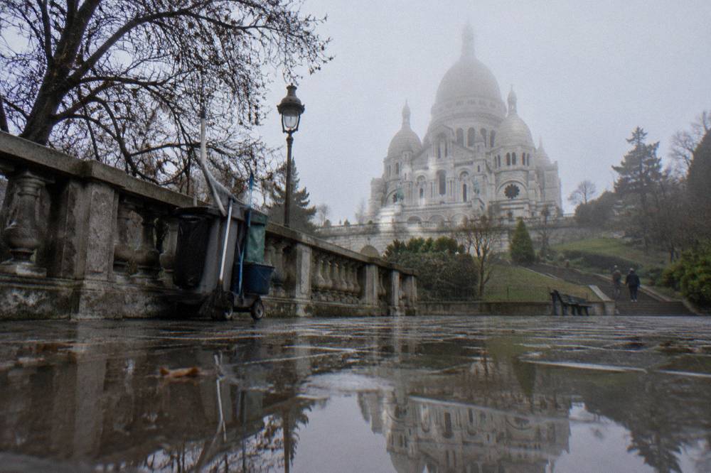 White domes of the Sacre-Coeur basilica seen from the terrace below