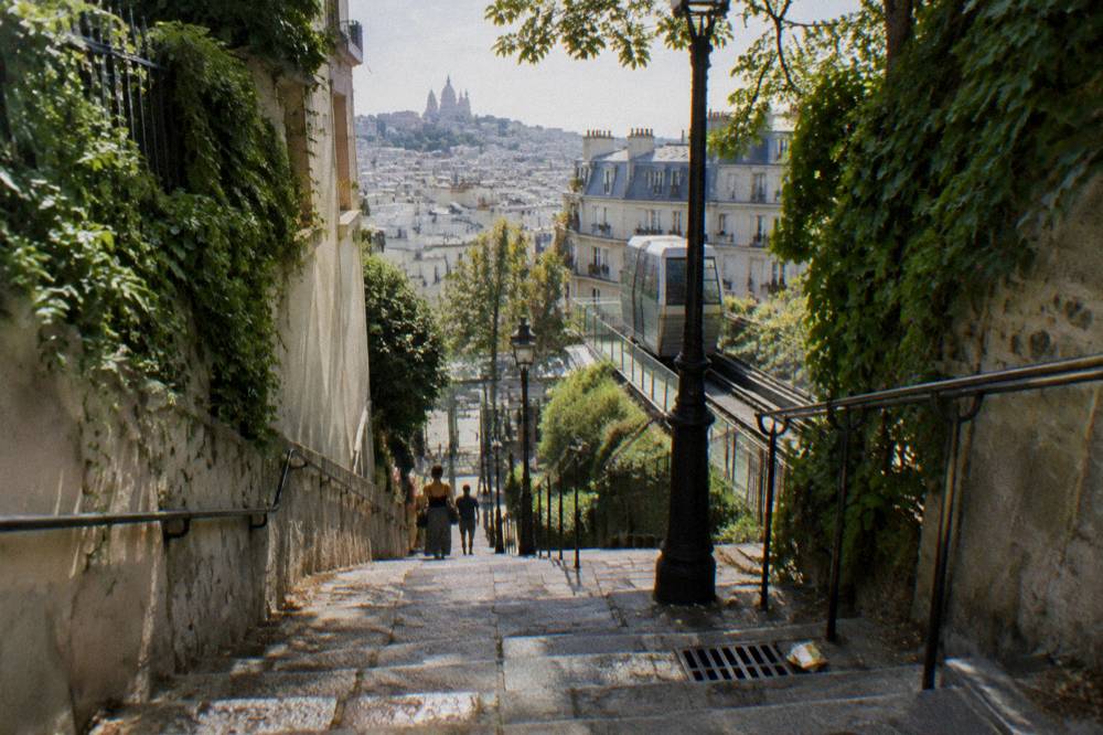 Stone stairway between ivy-covered walls leading up the Montmartre hillside