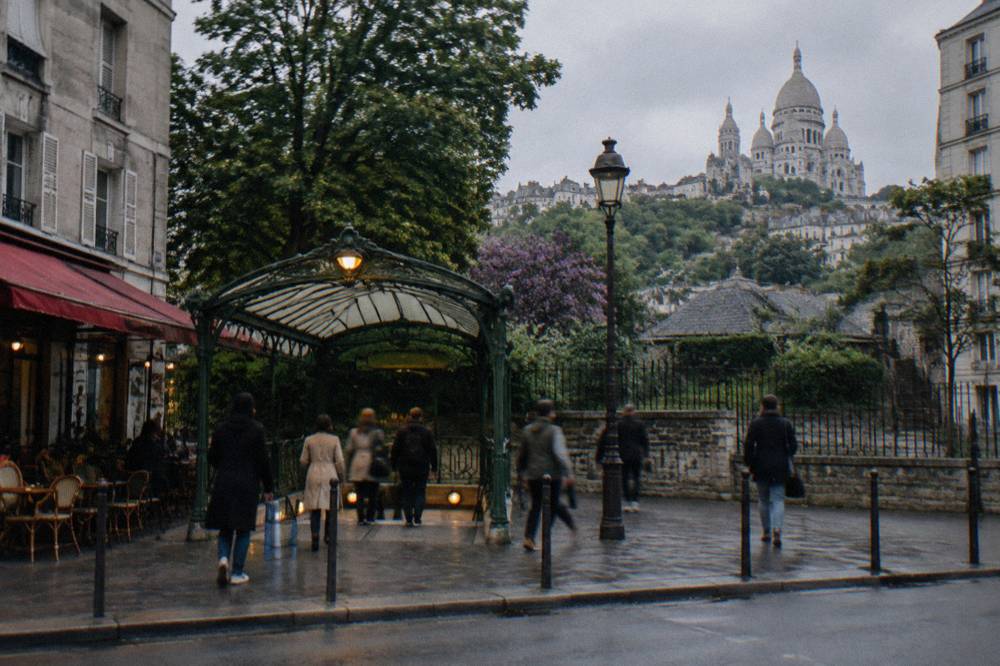 The Blanche metro station exit on Boulevard de Clichy with the hill rising in the background