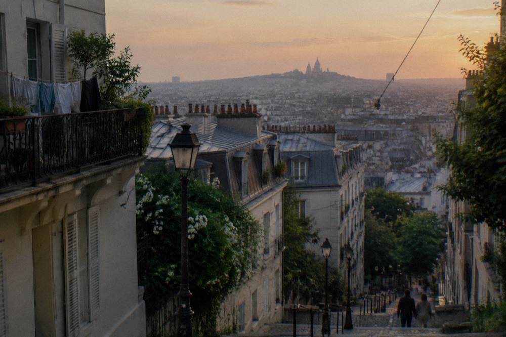 View over Paris rooftops from a high Montmartre street near the basilica