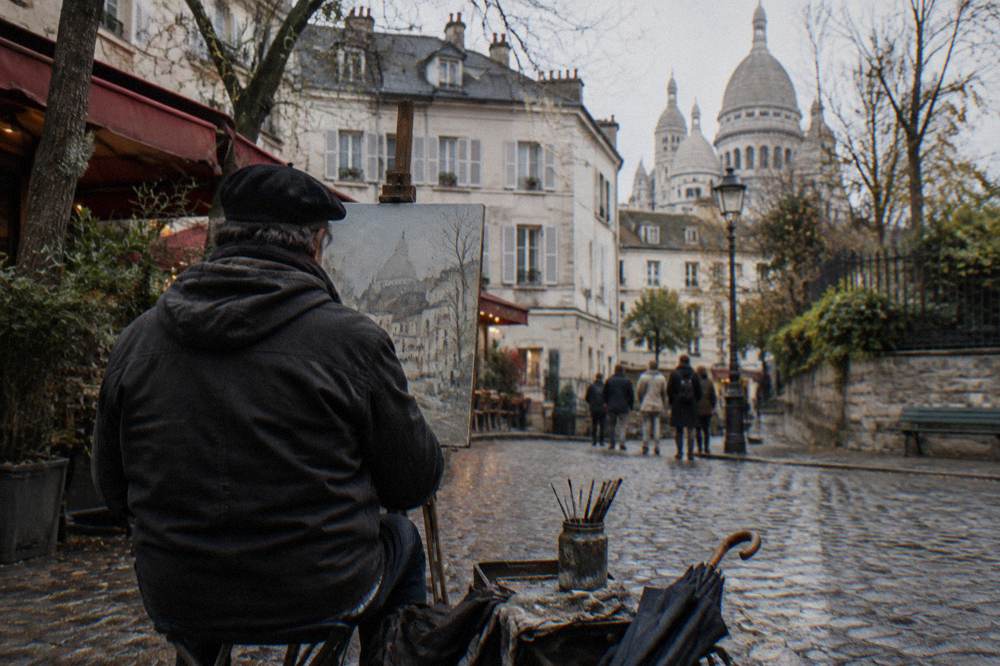 Painters with easels working at the artists square on top of the Montmartre hill