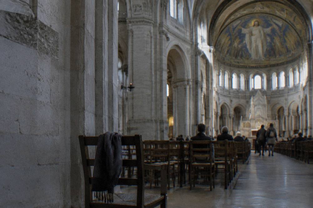 Interior of the Sacre-Coeur basilica with stone arches and light from high windows